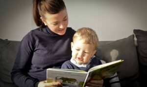 Child and babysitter read a book in Strasbourg