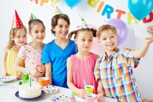 Children take a picture at birthday