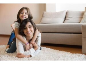 baby and babysitter smiling